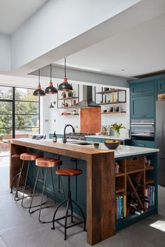 a kitchen with an island and bar stools