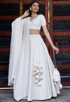 Faux Georgette Lehenga in White. This attire with Cotton Lining is Enhanced with Chicken Embroidery with Resham, Sequins work along with Fancy Tassels, Matching Potli and Can Can Net. Available with a Readymade Faux Georgette White Choli and a Faux Georgette Dupatta in White. The Readymade skirt will be provided. Lehenga Length is 40 inched.Do Note: Accessories shown in the image are for presentation purposes only and length may vary upto 2 inches.(Slight variation in actual color vs. image is p Lehenga Simple, Lehenga White, Chicken Embroidery, Fancy Tassels, Bridesmaid Dresses Indian, Indian Bridesmaid Dresses, Function Dresses, Simple Lehenga, White Lehenga