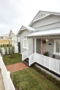 a house with white picket fence and green grass