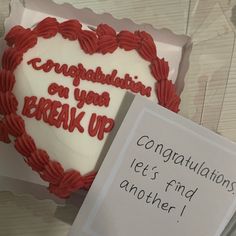 a heart - shaped cake with congratulations written on it and a note attached to the side