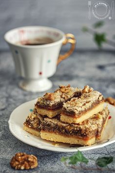 some food on a plate next to a cup of coffee