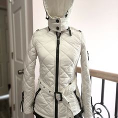 White Quilted Puffer Jacket By Burberry London. Detachable Hood With Adjustable . Long Sleeves. Zip-Front Closure. Adjustable Belted Waist. Antiqued Black Hardware. . Pockets Logo On All The Zippers Condition: Pre-Owned. Very Good. Est. Retail $ 995.00 It Says Us 6 But Fits Like At 2 If You Want To Zipper Up. Otherwise Open Can Fit A 4 White Quilted Jacket, Quilted Puffer Jacket, Burberry Jacket, White Quilt, Burberry London, Detachable Hood, Black Hardware, Quilted Jacket, Puffer Jacket