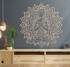 a woman is sitting in the middle of a lotus flower wall decal