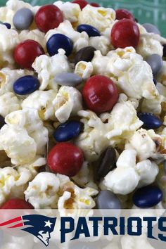 a close up of a bowl of popcorn with red, white and blue candy