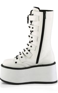 Dayum! The DAMNED-225 mid-calf platform boots are perfect for those who want some height with their stompy af boots without having to totter around on a heel. 6 studded buckled straps sit over full-length lace-ups with black trims on the white body creating a stunning contrast. SLip in n' out in a snap with the full-length inner zip. The DAMNED series features a 3 1/2 inch flatform. Material: 100% vegan PU leather. US women's sizing-refer to size chart for more info. Demonia Damned 225, Emo Boots, Hologram Shoes, White Platform Boots, Demonia Boots, Knee High Platform Boots, Alternative Shoes, Demonia Shoes, Vegan Leather Boots