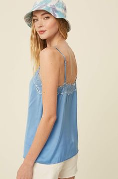 The Avery Silky Cami makes any look more chic! Style it solo or layer it up😉 -Textured silky polyester -V-neck with lace -Adjustable shoulder strap -Lace on neck, side and back -Imported -Content: 100% Polyester -Model is 5' 10" 33-24-35 and wearing a size Small Spring V-neck Lace Top With Delicate Straps, Spring Layering Camisole With Lace Trim, Spring Camisole With Lace Trim For Layering, V-neck Satin Camisole With Lace Trim, Chic Spaghetti Straps Lace Top For Daywear, Spring Satin Top With Lace Trim, Chic Lace Trim Camisole For Daywear, Silk Lace Trim Camisole For Spring, Silk Camisole With Lace Trim For Spring