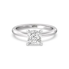 a white gold ring with a princess cut diamond