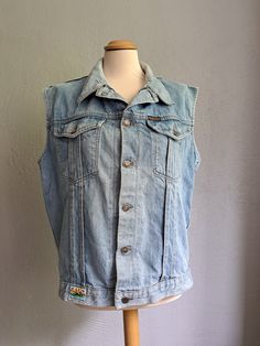 Vintage oversized denim vest Light blue denim vest Button down vest 90s aesthetic clothes Good vintage condition. See the photo. Composition - Cotton Brand - Paradiso. Made in Belgium Size - L Measurements: Length - 63 cm (24.8 in) From pit to pit - 54 cm (21.3 in) All measurements were taken on a horizontal surface. Cheap Retro Blue Denim Vest, Sleeveless Denim Vest With Pockets For Streetwear, Sleeveless Cotton Denim Jacket For Streetwear, Retro Blue Cotton Denim Vest, Blue Cotton Retro Denim Vest, Blue Retro Cotton Denim Vest, Sleeveless Cotton Denim Vest For Streetwear, Light Wash Cotton Denim Vest For Streetwear, Light Wash Sleeveless Cotton Denim Jacket