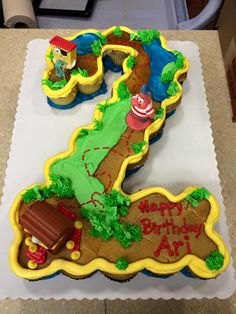 a birthday cake that looks like the number one for thomas the tank engine and friends