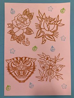 four stickers with different designs on them, including roses and tiger's head