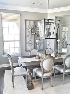 a dining room table with chairs and a chandelier