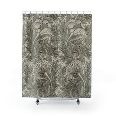 a shower curtain with an image of flowers and leaves on the outside, against a white background