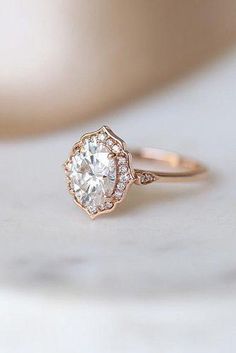 a close up view of a diamond ring on a marble surface