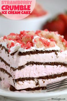 a close up of a piece of cake on a plate with strawberries in the background