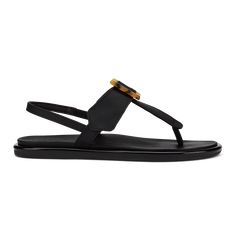 a pair of black sandals with gold accents