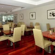 a restaurant with wooden tables and beige chairs