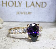 Don't miss this opportunity to own this beautiful gemstone ring crafted in 14k gold filled => Gemstone Type - Amethyst, Clear Quartz => Gemstone Cut - Faceted => Gemstone Size - 7*10 mm, 2.25 mm => Gemstone Shape - Pear Shape, Round Shape => Total Number of Gemstones - 9 => Metal Type - 14k Gold Filled (Tarnish Resistant And Nickel Free) - also available in 925 sterling silver * Please contact me for pricing on a sizes larger than 11 * ~ Feel free to ask me about custom made de Heirloom Jewelry With Accent Stones For Proposal, Pear-shaped Vs Clarity Ring For Proposal, Yellow Gold Teardrop Jewelry For Proposal, 14k Gold Gemstone Jewelry For Proposal, Fine Jewelry Teardrop Ring With Accent Stones, Gold Teardrop Rings For Proposal, Teardrop Solitaire Ring For Proposal, Solitaire Pear-shaped Jewelry For Proposal, Yellow Gold Teardrop Jewelry With Halo Setting