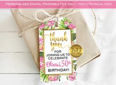 a thank you card with pink flowers and greenery on it, next to a gift bag