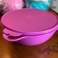 two pink tupperware dishes sitting on a table