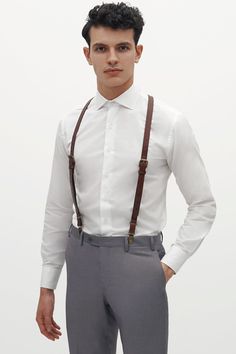 These leather suspenders from SuitShop are the perfect addition to your rustic wedding! One size fits all. Rustic in the front, comfy in the back! These suspenders are equal parts vintage and on-trend. EXCLUDED FROM PROMOS. RETURNS AND EXCHANGES OF THIS ITEM ARE HANDLED BY OUR FRIENDS AT SUITSHOP. | Brown Groomsmen Accessory | Birdy Grey Leather Suspenders By Suitshop How To Wear Suspenders, Blue Suit Vest, Brown Groomsmen, Groomsmen Accessories, Light Grey Suits, Black Suspenders, Leather Suspenders, Black Shawl, Navy Blue Suit