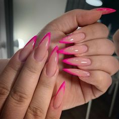 a woman's hand with long pink nails