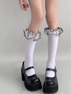 Indulge in timeless elegance with our white/black ruffled cuff sweet stockings. Designed for those who adore a blend of classic and contemporary, these stockings feature delicate ruffled cuffs that add a touch of sweetness to any outfit. Crafted from high-quality, breathable fabric, they ensure comfort while maintaining a chic appearance. Perfect for pairing with Lolita dresses, kawaii skirts, or even casual wear, these stockings are a versatile addition to your wardrobe. Elevate your style effo Elegant Black Knee-high Socks, Fitted White Ruffled Socks, Elegant Black Socks For Spring, Elegant White Socks For Spring, Elegant Spring Stockings With Lace Trim, Elegant Lace Trim Stockings For Spring, Elegant White Lace Trim Stockings, Elegant Knee-high Stockings For Spring, Elegant Black Legwear For Spring