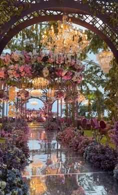 an elaborate garden with flowers and chandeliers