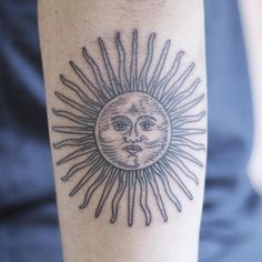 a sun and moon tattoo on the arm