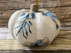 a painted pumpkin sitting on top of a wooden table