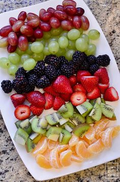 fruit platter with grapes, kiwis, oranges, and strawberries