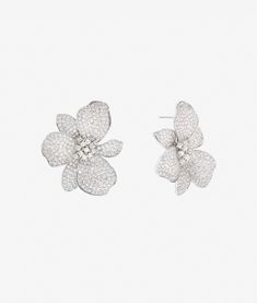 The Iconic Eden Flower Earring is a statement of refined elegance, perfect for weddings and evening occasions. Featuring a romantic floral silhouette, this earring is adorned with hand-set AAAA+ grade cubic zirconia pave, creating a dazzling effect. Its intricate detailing and timeless design make it a standout accessory for sophisticated styling. Material: 925 Sterling Silver Stones: AAAA+ Grade Cubic Zirconia Pave Measurement: 40mm (1.57 inches) The Eden Flower Earring combines delicate crafts Luxury White Cubic Zirconia Flower Earrings, Elegant Cubic Zirconia Flower Earrings, Elegant Flower-shaped Cubic Zirconia Diamond Earrings, Elegant Cubic Zirconia Flower Earrings In Brilliant Cut, Elegant Diamond Flower Earrings With Sparkling Stones, Luxury Flower Diamond Earrings, Luxury Silver Diamond Flower Earrings, Elegant Brilliant Cut Cubic Zirconia Flower Earrings, Silver Pave Setting Bridal Earrings