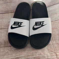 New No Tag Size 11 White And Black Nike Black Slides With Rubber Sole, Sporty Slides With Round Toe And White Sole, White Non-slip Sporty Slides, Black Slides With Rubber Sole, Black Low-top Slides With Rubber Sole, Sporty White Slides For Sports, Nike Black Sporty Slides, Sporty Black Nike Slides, Nike White Non-slip Slides