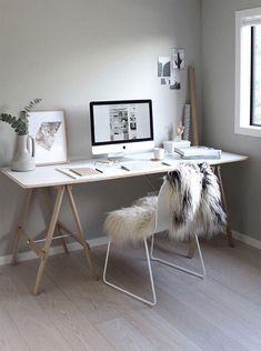 a white desk with a computer on top of it