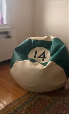 a bean bag chair sitting on top of a wooden floor next to a radiator