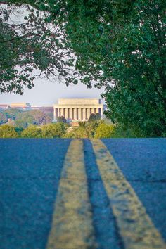 an image of the lincoln memorial through some trees