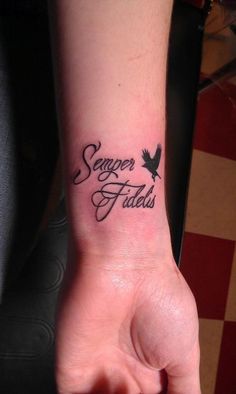 someone has a tattoo on their wrist that says semper fadis and an eagle