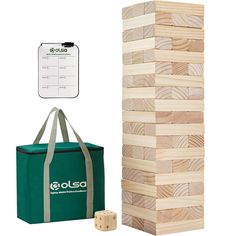 a wooden block tower next to a bag