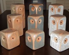 six wooden blocks with holes in them on a table