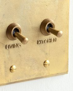 two knobs on a wall with the words living kitchen