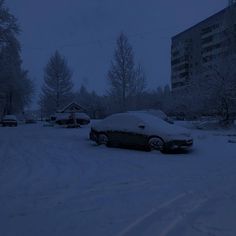 a car covered in snow parked on the side of a road