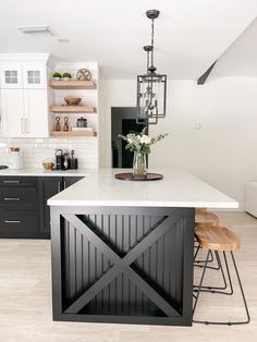 a kitchen island with two stools next to it