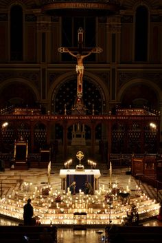 the interior of a church lit up with candles