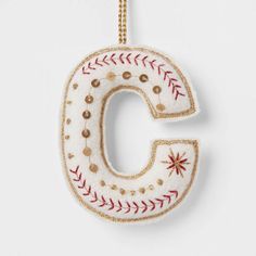 a baseball ornament with the letter c on it