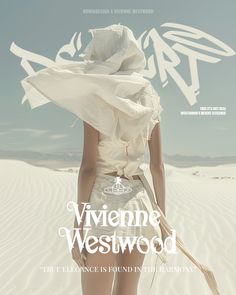 a woman in a white dress and hat walking across a sandy area with the words viviene westwood on it