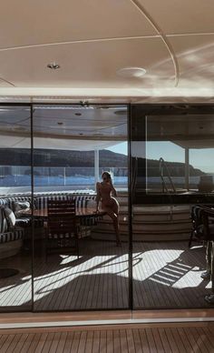 a woman sitting at a table on top of a boat