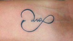 a tattoo with the word love written in cursive writing