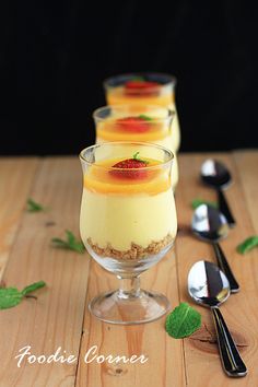 three desserts in small glasses on a wooden table