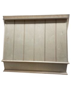 a white shelf with wooden paneling on it