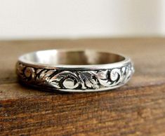 a silver ring sitting on top of a wooden table