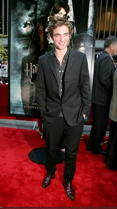 a young man in a suit and tie at the harry potters world film premiere